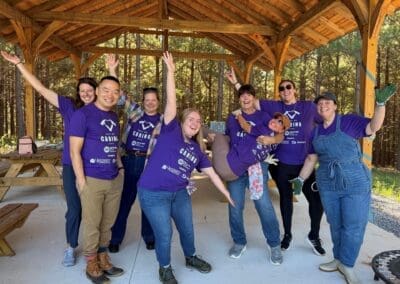 UVA volunteers striking a playful pose under the Autism Sanctuary pavilion