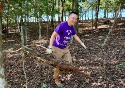 Team members collaborating to remove fallen limbs during pasture rehabilitation